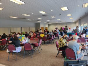Interior image of the Roseville Skate Center with individuals playing games and chatting.