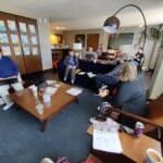 Individuals meeting in a hotel room